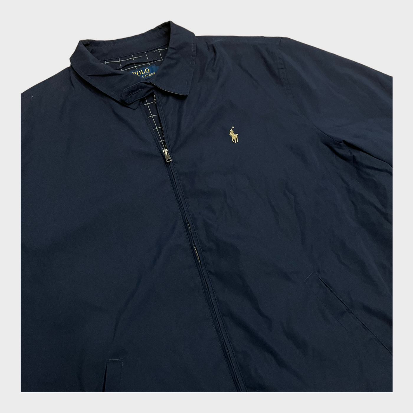 Close-up of the RALPH LAUREN harrington jacket in navy blue.